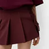Fusta mini cu pliuri cutie cu detaliu fundita Fusta mini cu pliuri cutie cu detaliu fundita