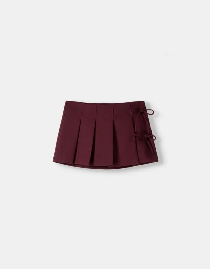 Fusta mini cu pliuri cutie cu detaliu fundita Fusta mini cu pliuri cutie cu detaliu fundita